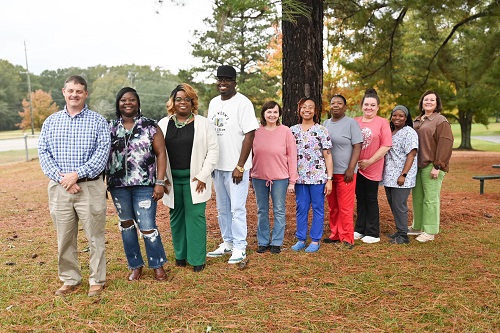 (Left to Right): (Administrators) Kevin Polk, Director of Units; (Winners) Clotee Feazell, Felinda Kelly, Andre McDonald, Shannon Bates, Kendra Lyons, Stephanie Allen, Lisa Holifield, Monique Terrell; (Administrators) Candy Maxey, Assistant Director of ESS.